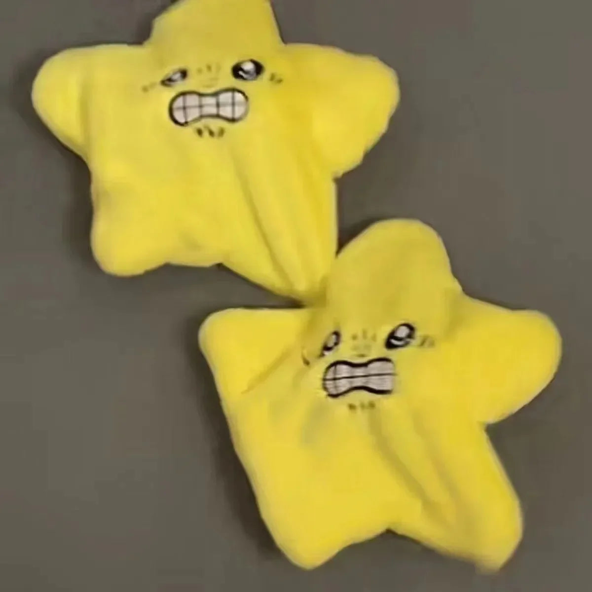 A yellow star-shaped plush toy with a surprised or angry facial expression.
