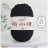 A ball of black chenille yarn with a white label featuring Chinese characters and the number 34.