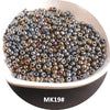 A pile of small, iridescent metallic glass beads in various shades of bronze and silver on a white dish.