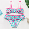 A pink and teal two-piece swimsuit set for girls featuring a vibrant rainbow print.
