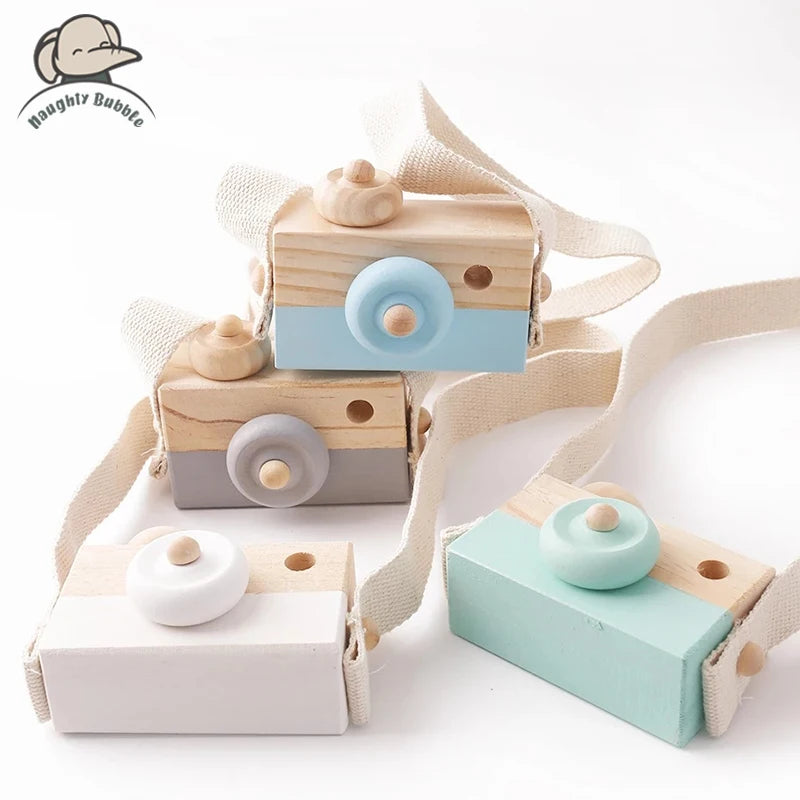 A set of wooden camera teether toys in light wood and pastel blue colors for baby teething