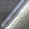 A white luminous anime katana prop with an LED blade is shown angled against a textured wall.