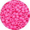 A close-up view of small, round pink pony beads for jewelry making