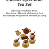 A silicone afternoon tea set for kids featuring various cups, teapot, and food items like cookies.