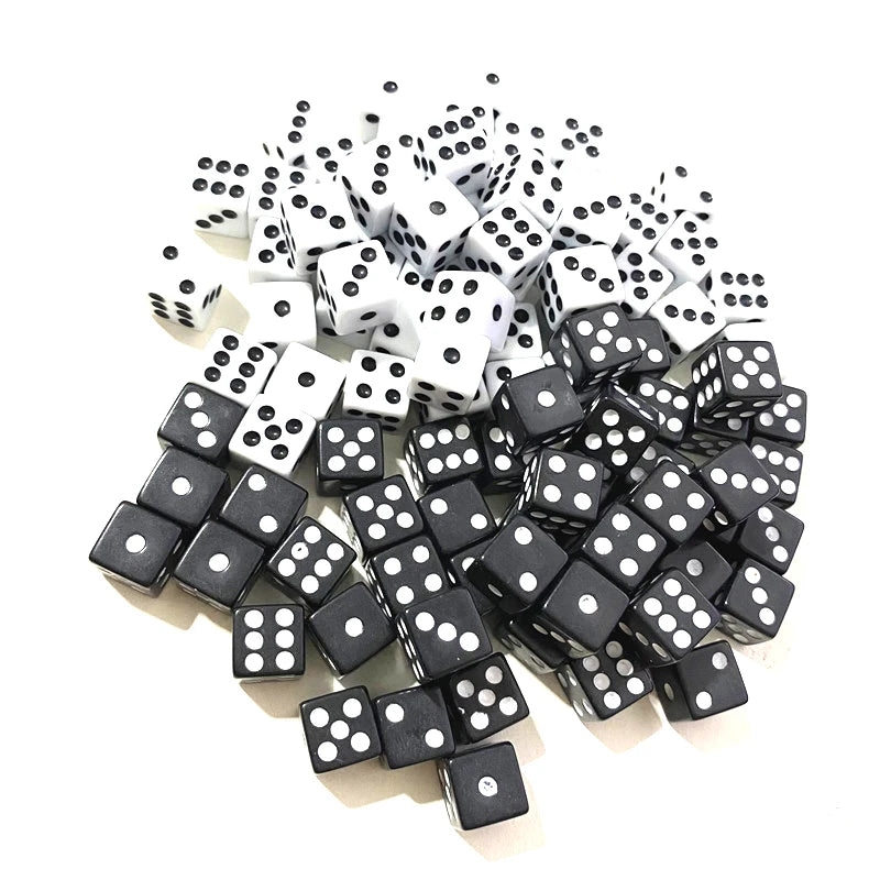 A pile of black and white 10mm six-sided dice for games and decision making