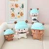 A set of cute panda bear plush toys wearing light blue hats, displayed on a white sofa.