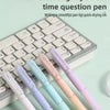 A set of five new color slightly sweet time question pens with smooth tips displayed on a keyboard.