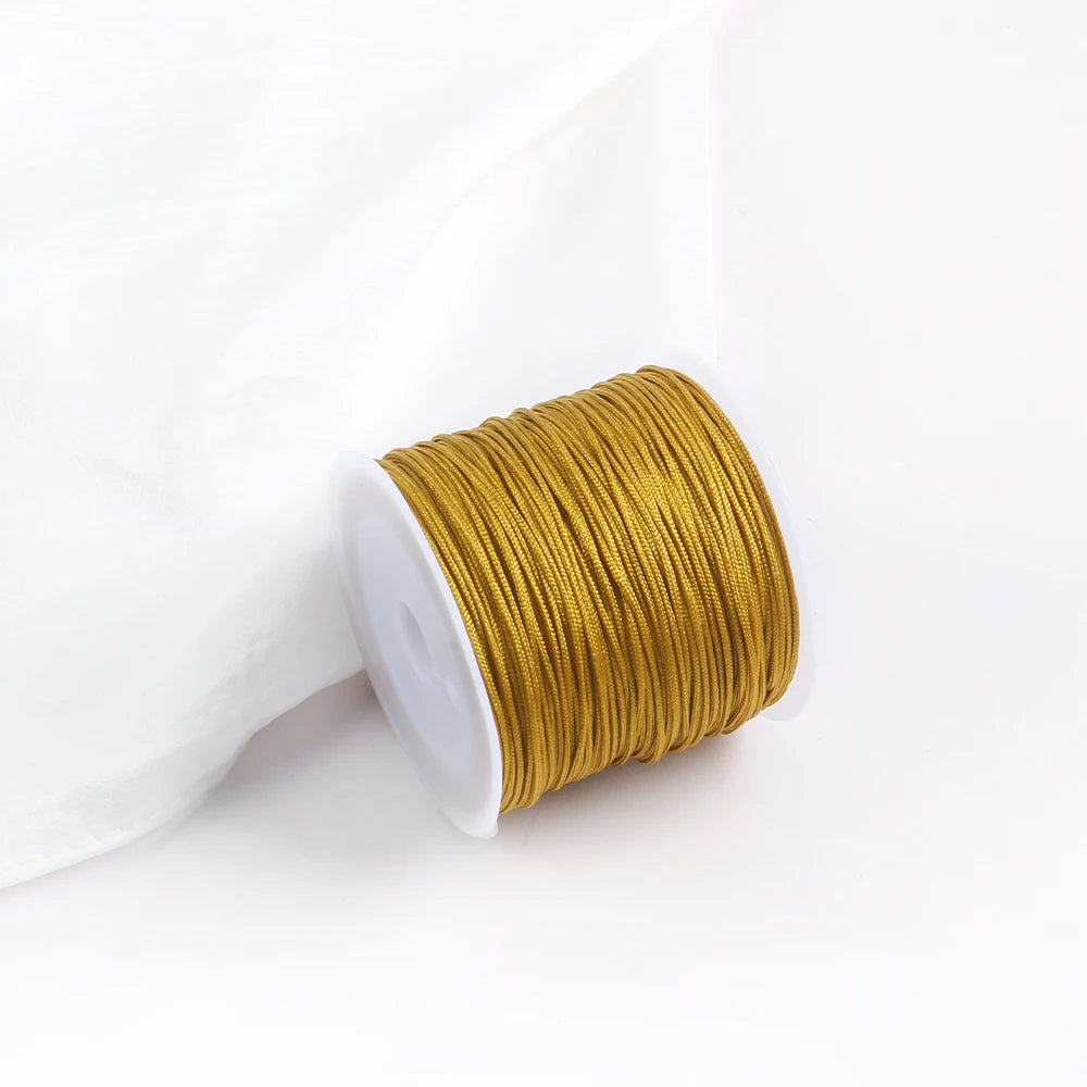 A roll of golden yellow 0.8mm cotton nylon macrame cord for jewelry making and crafts.