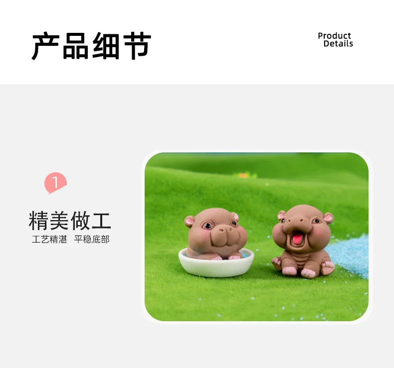 A pair of small, brown resin hippo figurines sitting on green grass.