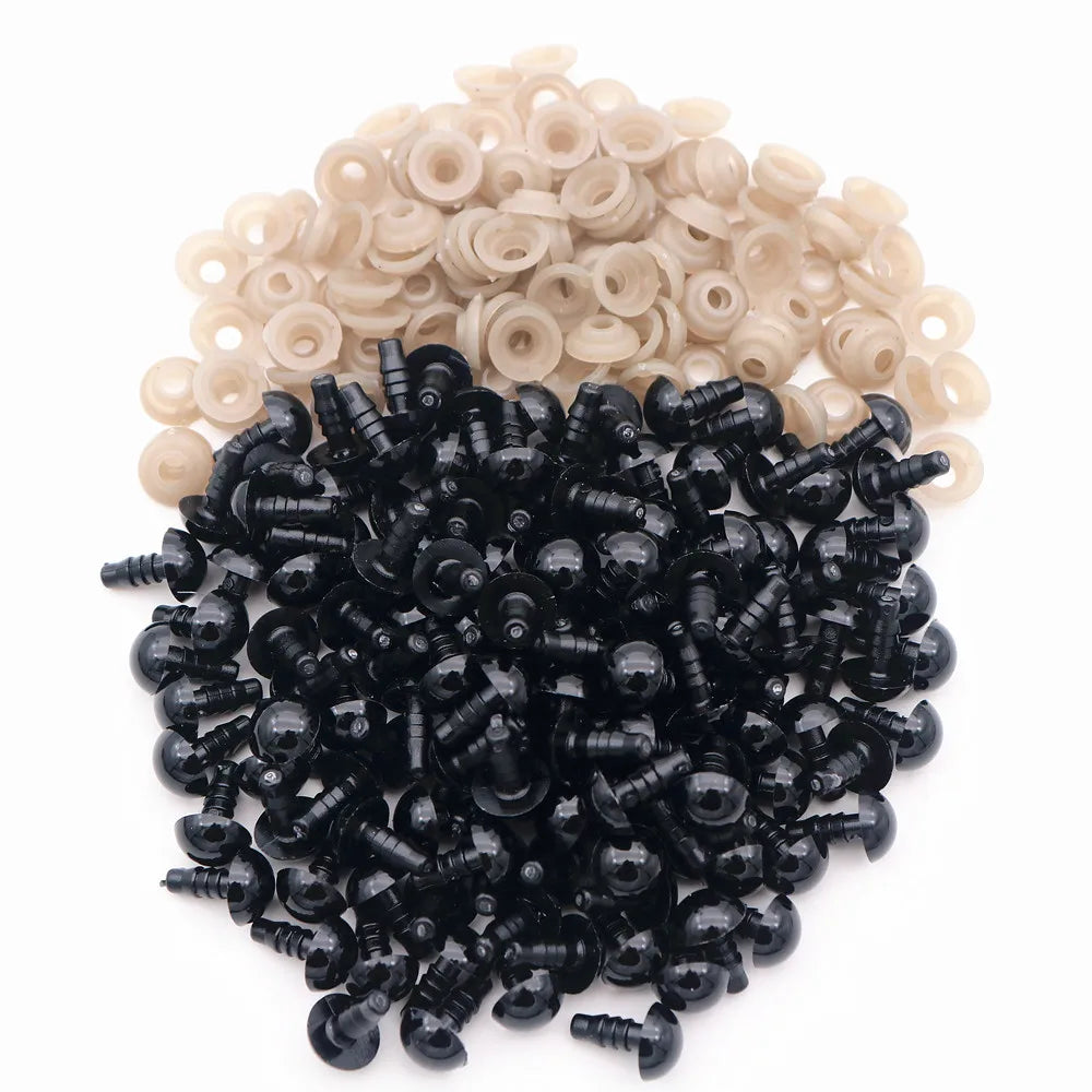 A pile of black plastic safety eyes with washers for crafting and stuffed animals