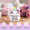 Handgefertigtes Häkel-Einhorn-Puppen mit rosa und lila Akzenten auf einer Holzoberfläche.