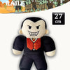 A black plush toy resembling a monster with sharp teeth and an angry expression.