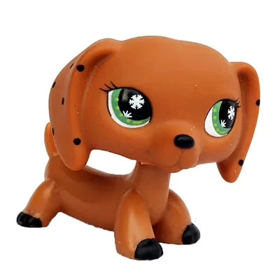 A small, orange Bobbing Deer bobblehead toy with green glowing eyes.