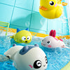 Colorful bath toys including a yellow duck, a yellow cat, and a white animal floating in blue water.