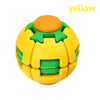 A yellow, burger-shaped stress relief toy with a green top and orange button.