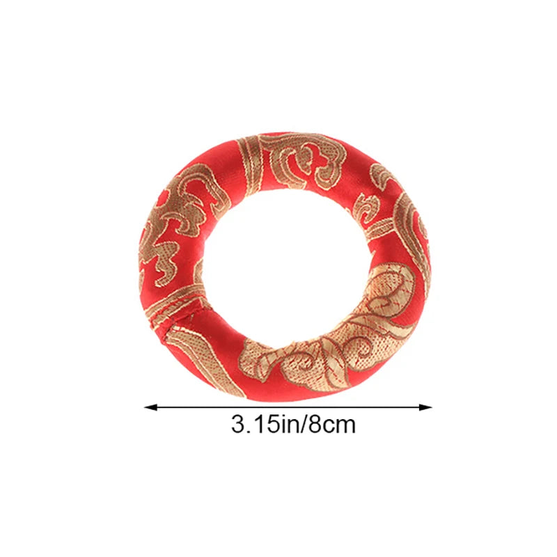 Handmade red singing bowl cushion featuring gold embroidery
