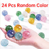 A hand holds 24 assorted random color glitter bouncy balls on a white background.