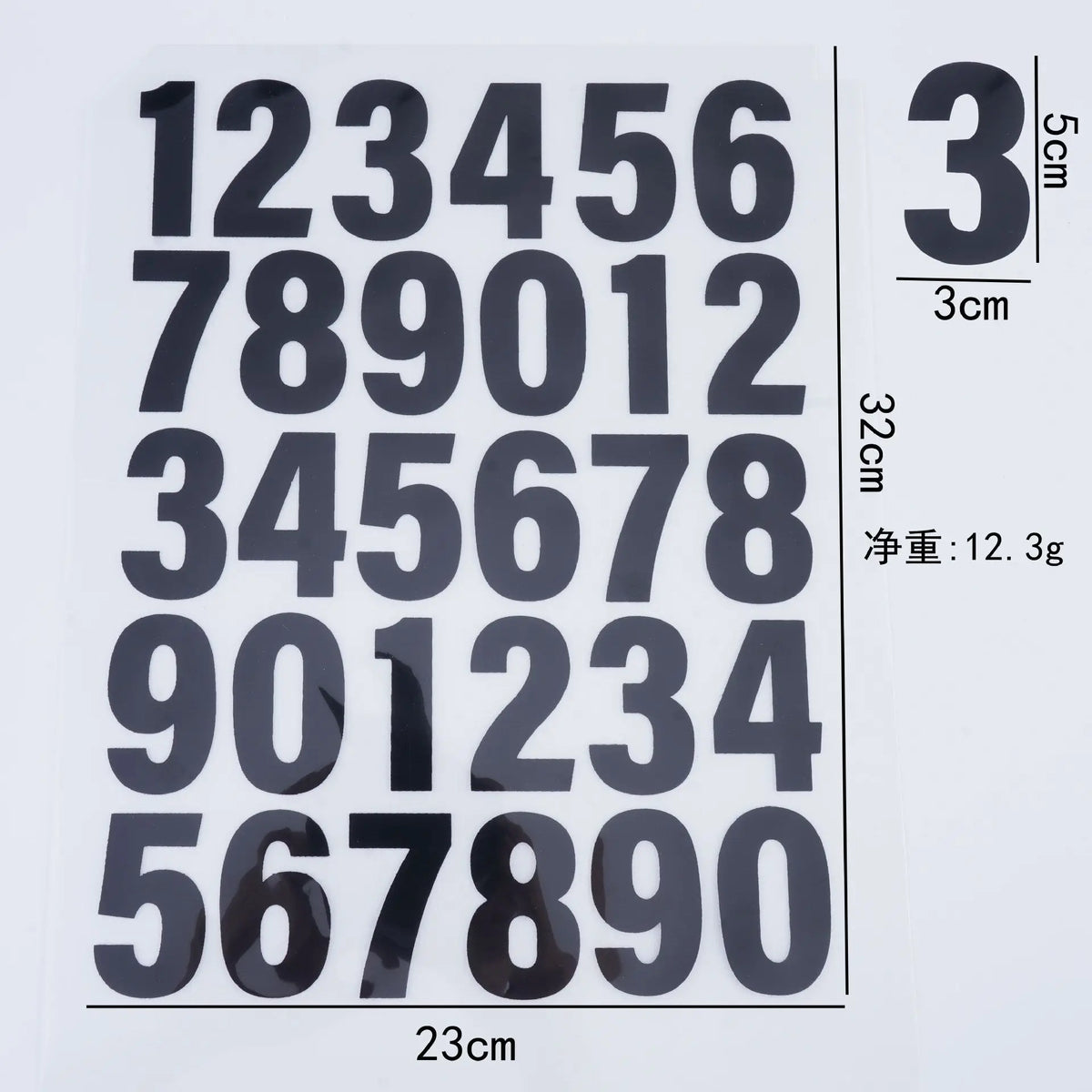 A sheet of black iron-on heat transfer patches showing a grid of numbers 1 through 9 repeated in various arrangements.