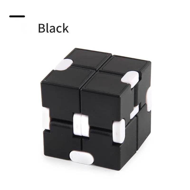 A black fidget cube with white accents shown from above.