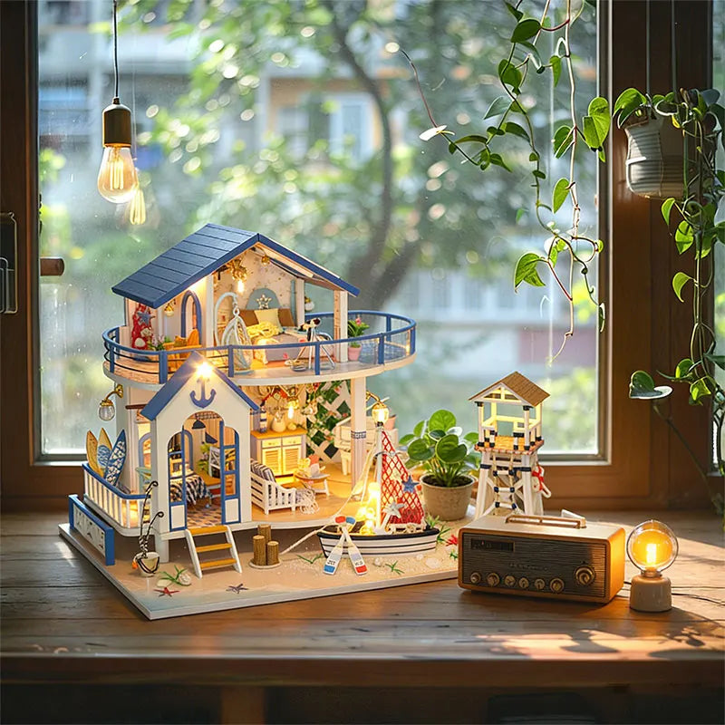 A miniature seaside beach house dollhouse kit with an LED light displayed on a wooden table.