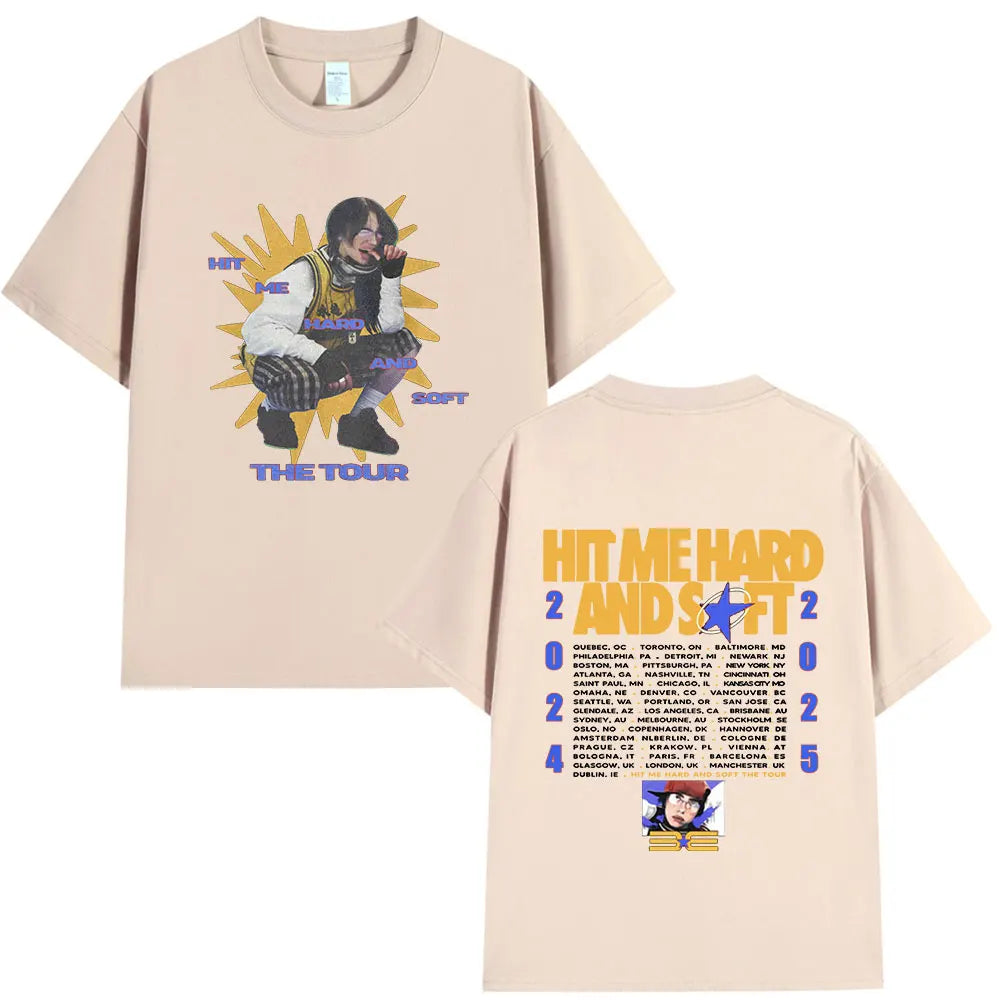A light pink t-shirt featuring a graphic design for the Hit Me Hard and Soft tour.