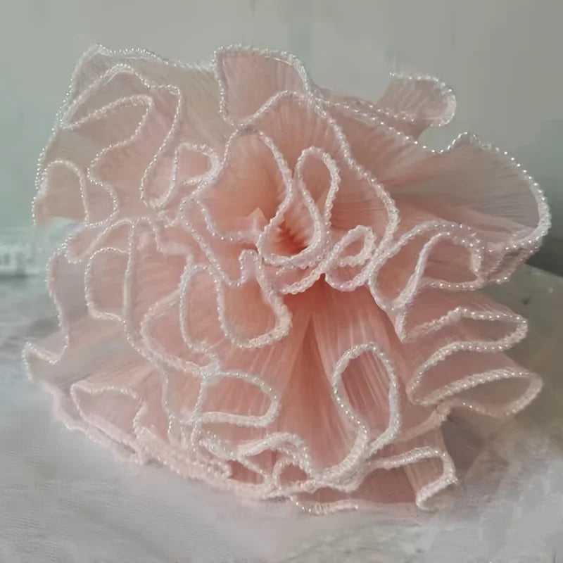 A light pink pleated wavy wrapping mesh bouquet with delicate beading.