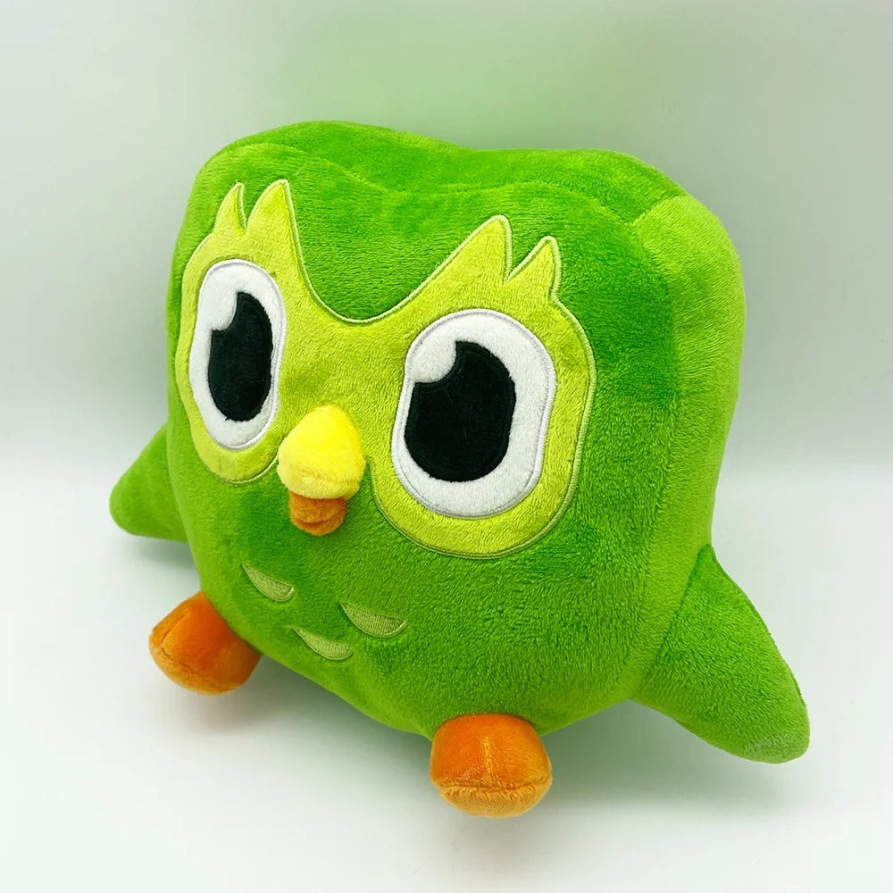 A soft green plush toy of Duo the Owl with large eyes and orange feet.