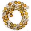 A collection of round, polished natural sea sediment jasper and turquoise beads for jewelry making.