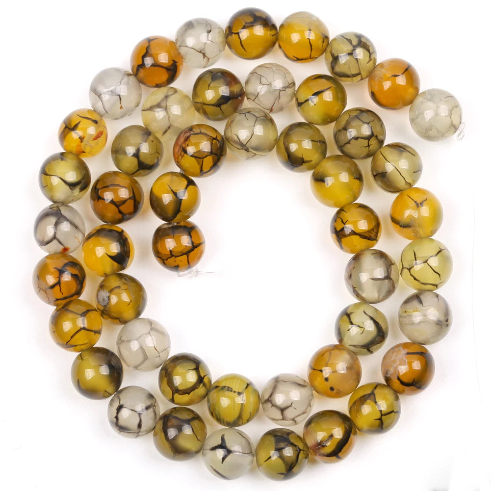 A collection of round, polished natural sea sediment jasper and turquoise beads for jewelry making.