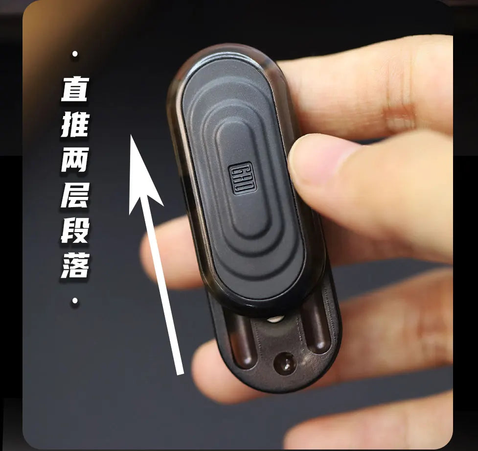 A hand holds a black EDC push slider fidget toy with concentric ridges, demonstrating its use for stress relief.