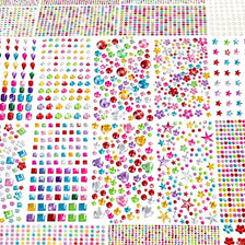 A dense collection of colorful acrylic gemstone rhinestones and glitter stickers in various shapes and sizes.