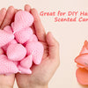 Hands holding pink strawberry silicone molds used for DIY handmade scented candles