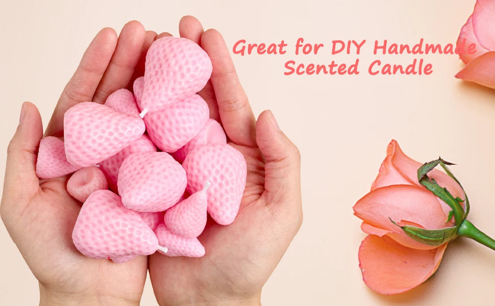Hands holding pink strawberry silicone molds used for DIY handmade scented candles