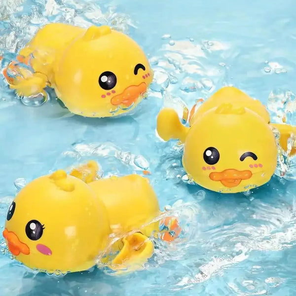 A yellow cute duck bath toy floating in clear water.