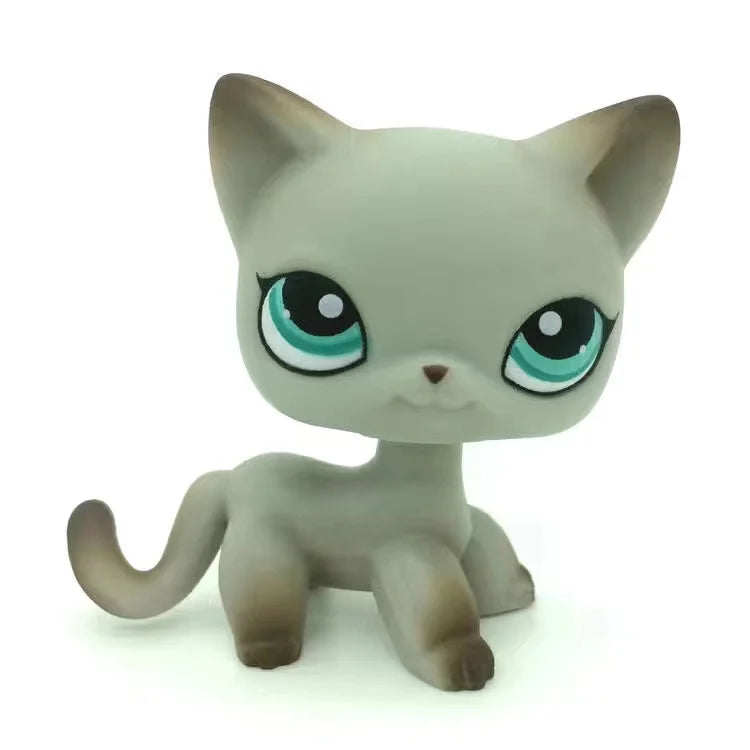 A small, gray Littlest Pet Shop style standing dog figure with large green eyes.