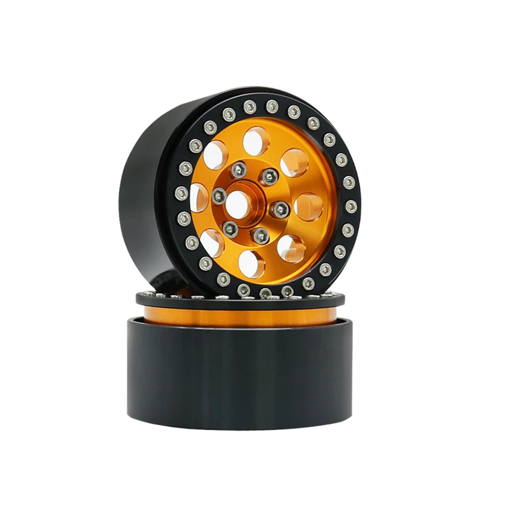 A black beadlock wheel with an orange center and removable hex hub for an RC crawler.
