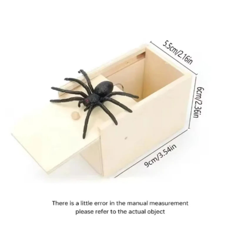 A light wood box containing a preserved black spider used as a prank or gag gift.
