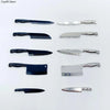 A collection of miniature metal kitchen knives in various sizes and finishes for a dollhouse