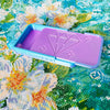 A purple diamond painting organizer tray with storage compartments is shown on a colorful background.