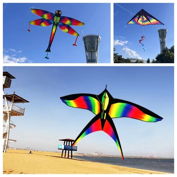 A colorful rainbow nylon kite is flying against a blue sky with a cityscape in the background.