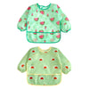 A pair of light green waterproof baby bibs with a watermelon pattern.