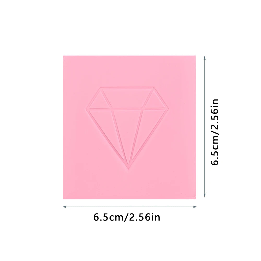 A square block of pink diamond painting clay with a diamond shape molded into the surface.
