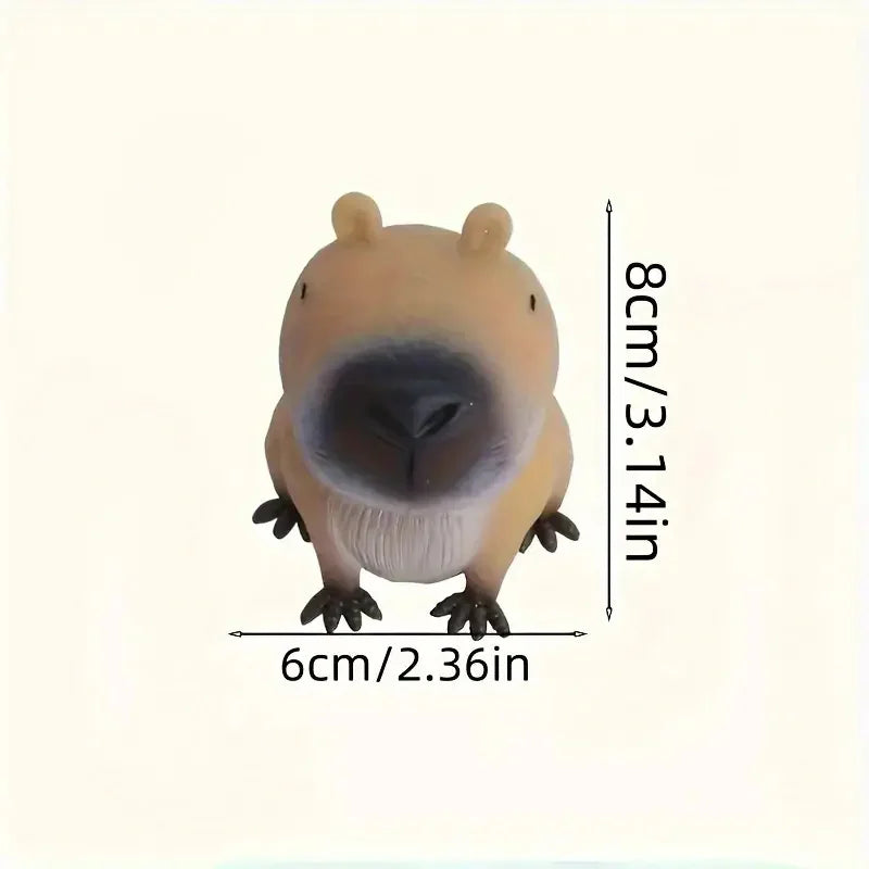 A light brown squishy toy shaped like a capybara with a dark nose and small paws.