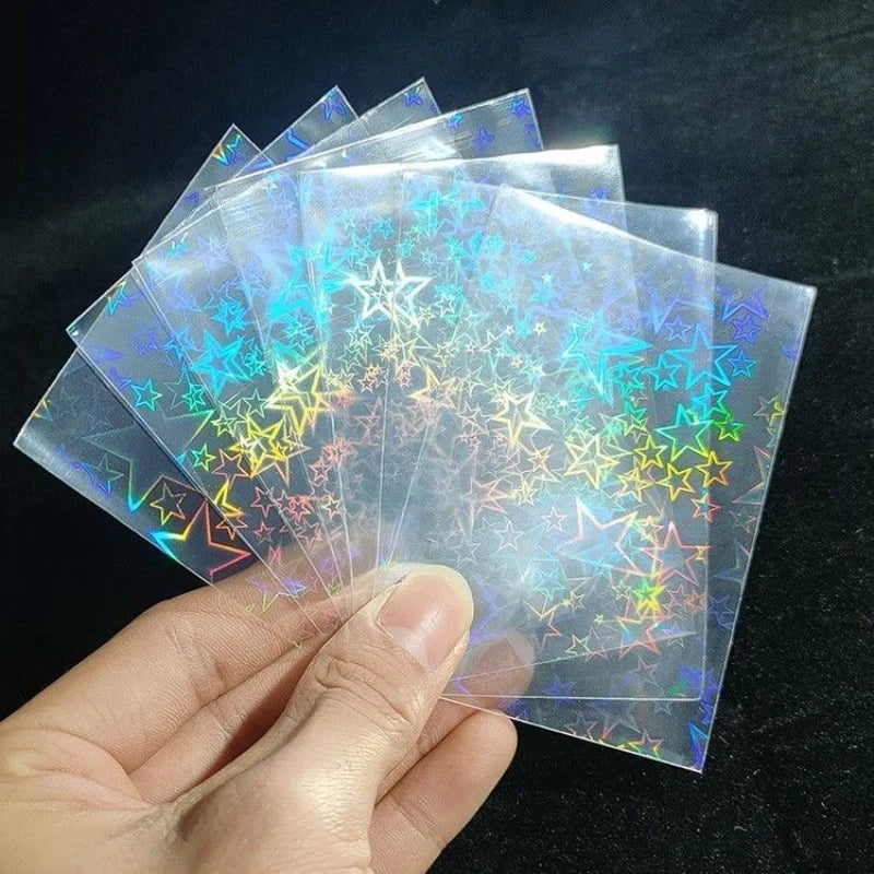 A hand holds a stack of holographic card sleeves for trading card games