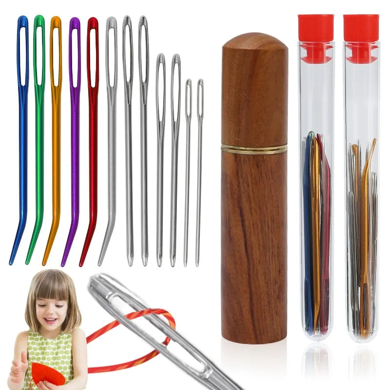A set of large eye stainless steel sewing needles with a wooden storage tube and a red cap.