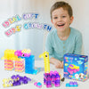 A young boy smiles while holding a colorful set of gummy block building toys.