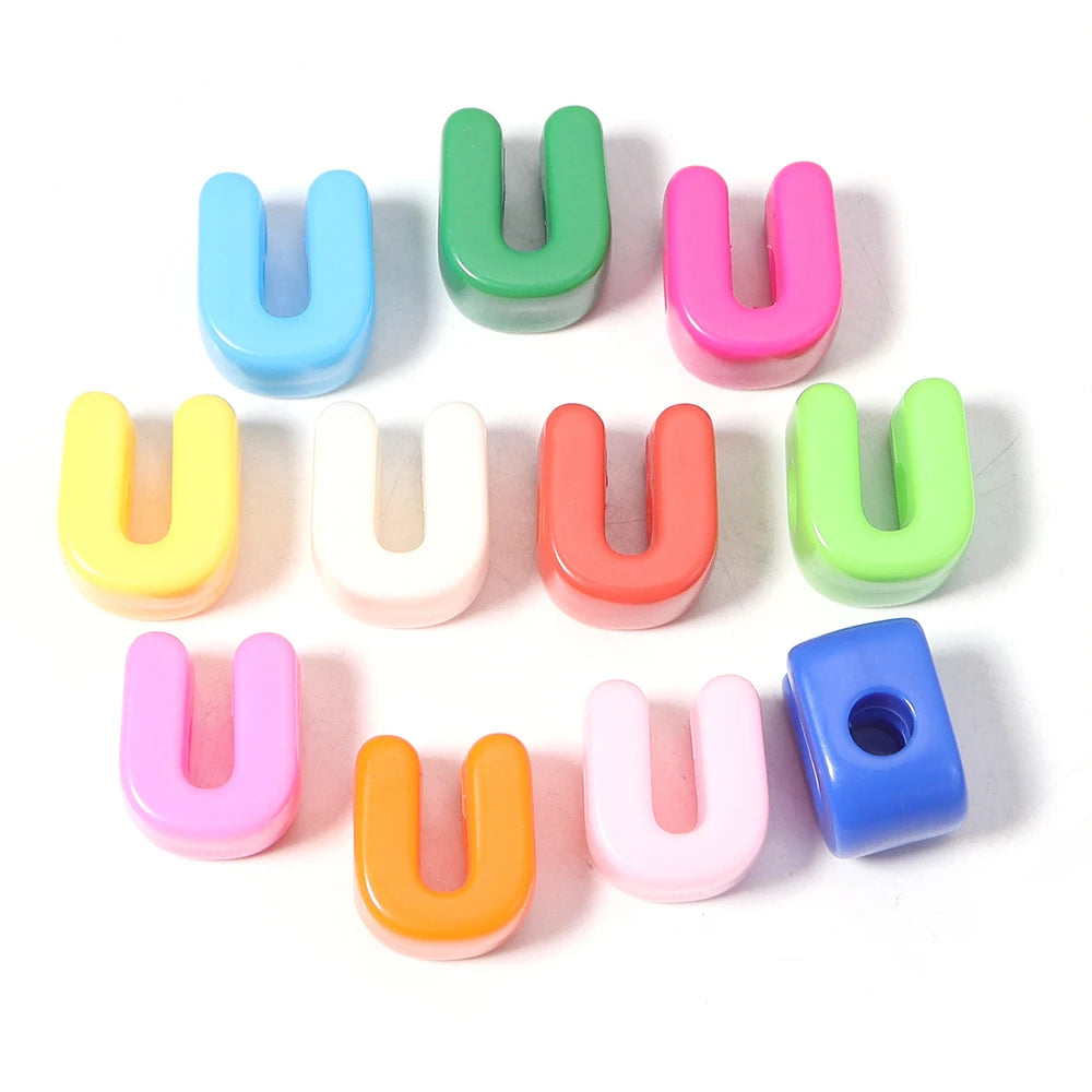 A collection of colorful acrylic letter U beads in various shades including green, pink, blue, and yellow.