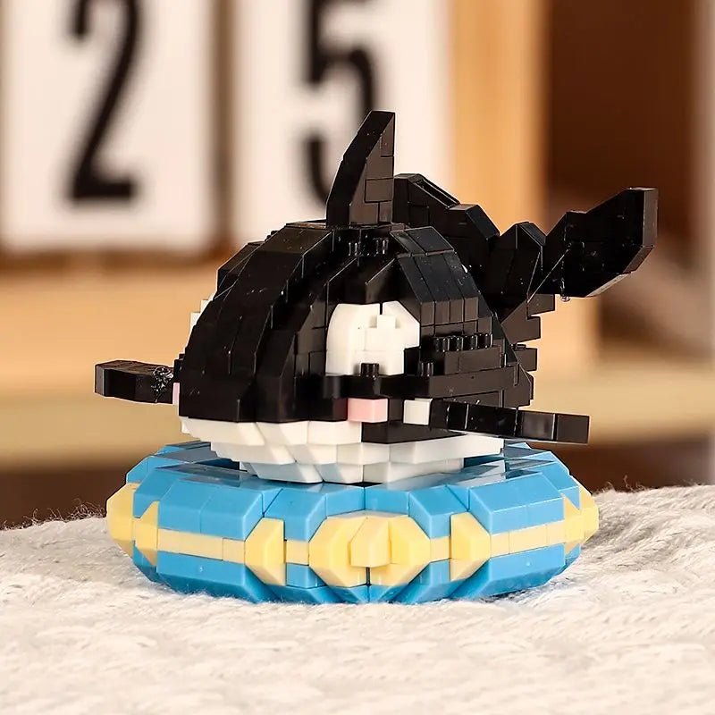 A black and white shark building block figure with a blue base, set against a blurred background.