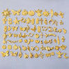 A collection of gold-colored mixed metal charms and pendants for DIY jewelry making.