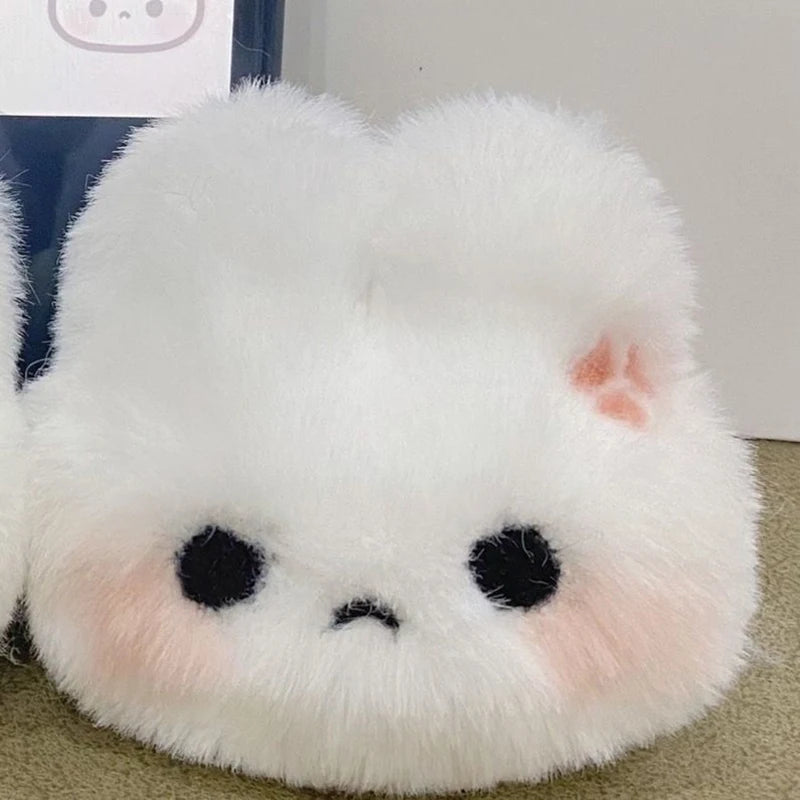 A white plush rabbit charm with black eyes and pink accents.